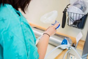 Pregnant Woman Holding Nitrous Oxide (Laughing Gas) Mask